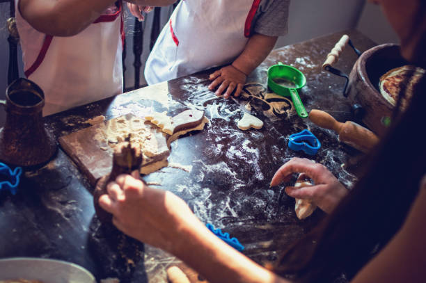 istock Young family cooking in kitchen. Teaching to bake 912325942