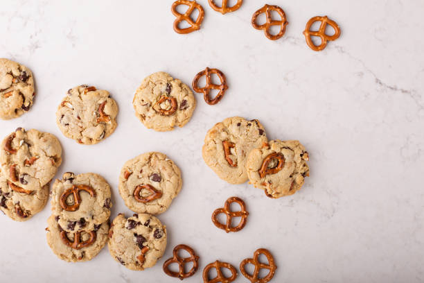istock Chocolate chips and pretzels cookies on a marble table 912326242