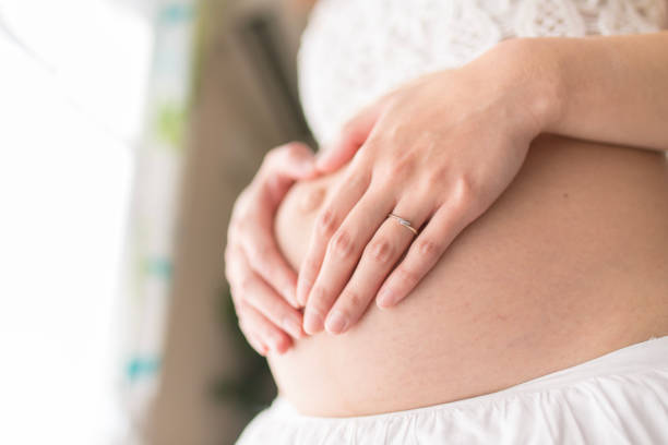 Young woman holding belly