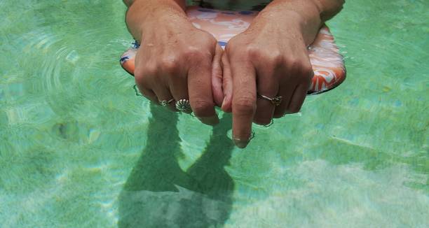 istock Cropped shot of woman's hands using kick board in swimming pool. 912327484