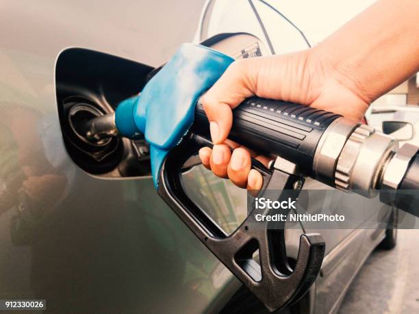 Hand Holding Gasoline Nozzle Stock Photo - Download Image Now - Refueling, Fuel Pump, Gasoline