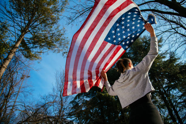 istock Woman holding an American flag 912330272