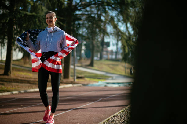 istock Female athlete holding an American flag 912332586