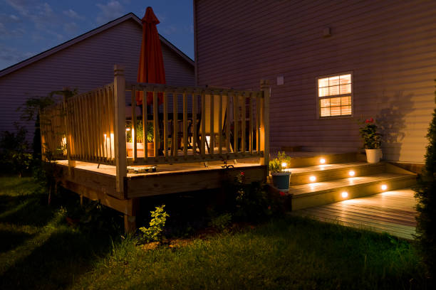 Wooden deck and patio of family home at night. stock photo