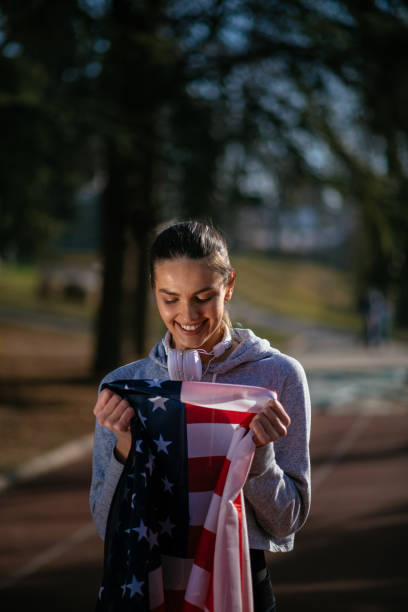 istock Happy female athlete holding an American flag. 912333068