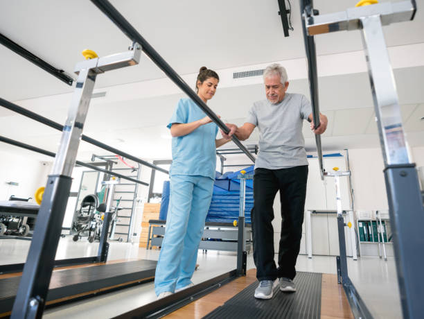 istock Beautiful physiotherapist helping a senior patient on his recovery walking between parallel bars 912333894