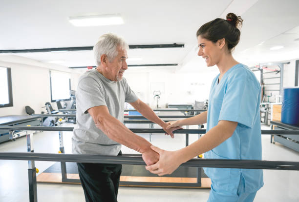 istock Occupational therapist and senior patient using the parallel bars to walk 912334126