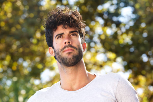 istock Close up serious handsome man with beard outside in nature 912334558