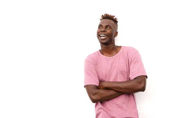 istock Smiling african guy in t-shirt looking at copy space against white background 912334596