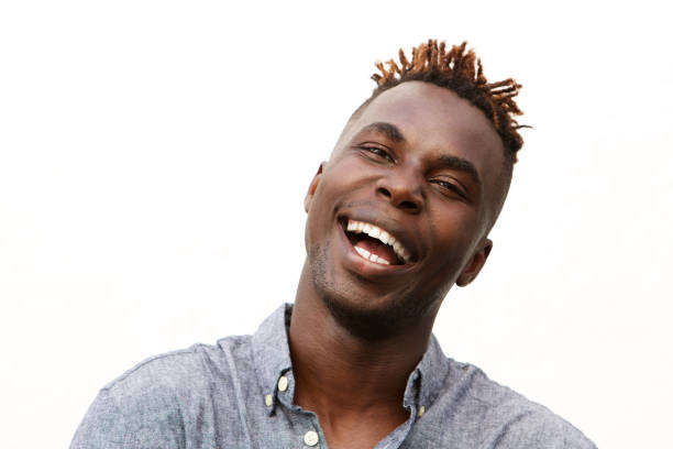istock Close up handsome young man laughing against white background 912334682