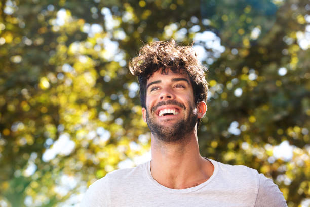 istock Close up laughing handsome man with beard outside in nature 912334710