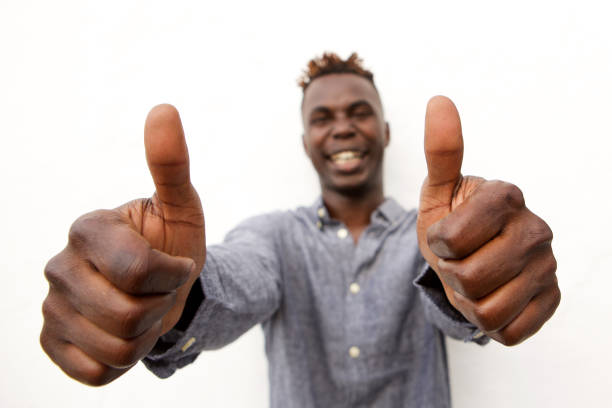 istock Positive young african man smiling with two thumbs up 912334750