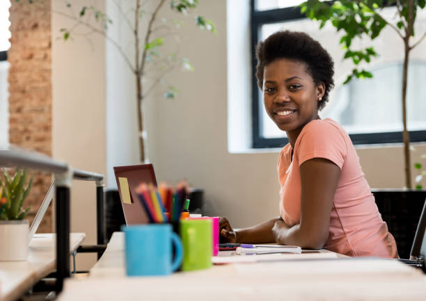 istock Happy black woman working online at a creative office 912334806