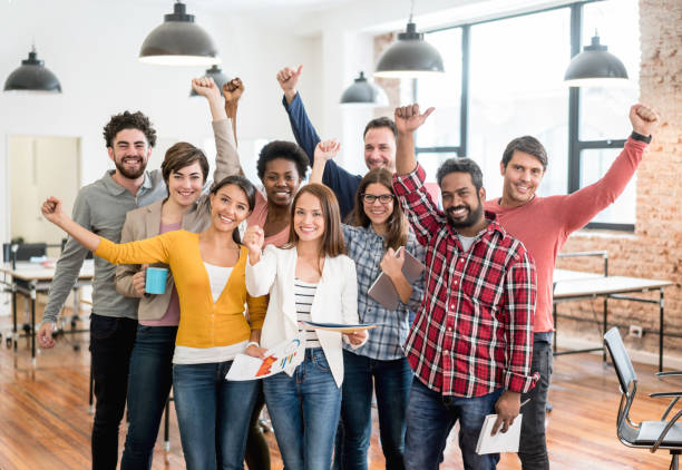 istock Excited group of people celebrating at a creative office 912334848