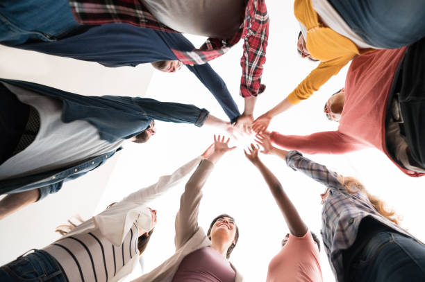 istock Group of workers with hands together in a circle at a creative office 912334940