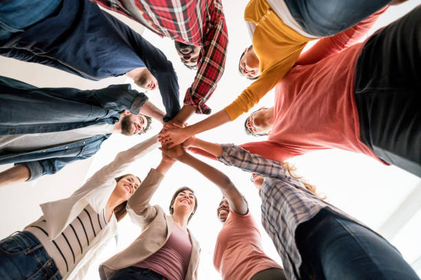 istock Group people in a circle with hands together at the office 912334968