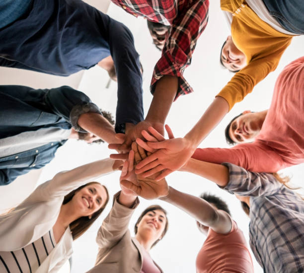 istock Group of workers with hands together in a circle - teamwork concepts 912335000