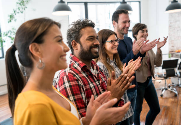 istock Group of workers applauding in a business meeting at a creative office 912335036