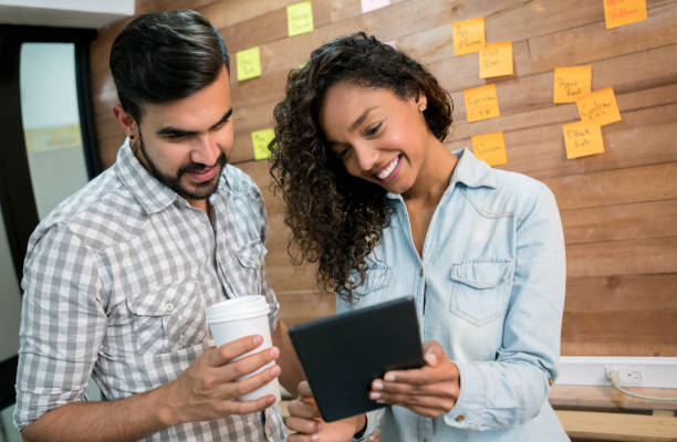 istock Couple of people working together at a creative office 912338280