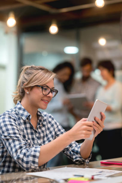istock Business woman working at a creative office using her cell phone 912338328