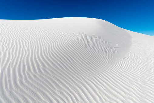 White gypsum sand dunes and blue sky in White Sands National Monument, southern New Mexico.