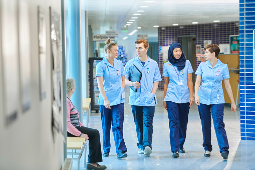 four young nurses walking along in the hospital
