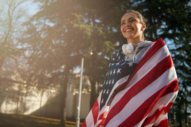 istock Woman holding an American flag 912341442