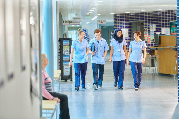 istock young nurses chatting on the way to ward 912341618