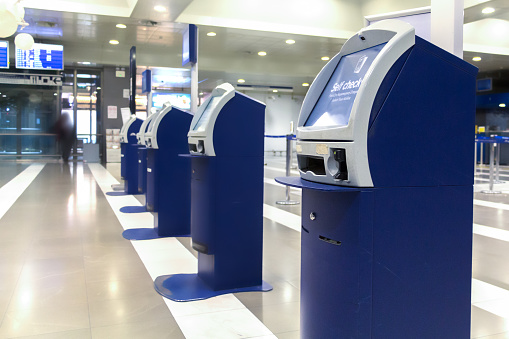 A line of auto check-in machine at the check-in counters area inside a Greek Airport.
