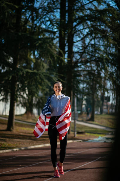 istock Female athlete holding an American flag 912341808