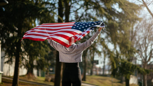 istock Young female athlete with an American flag 912343884