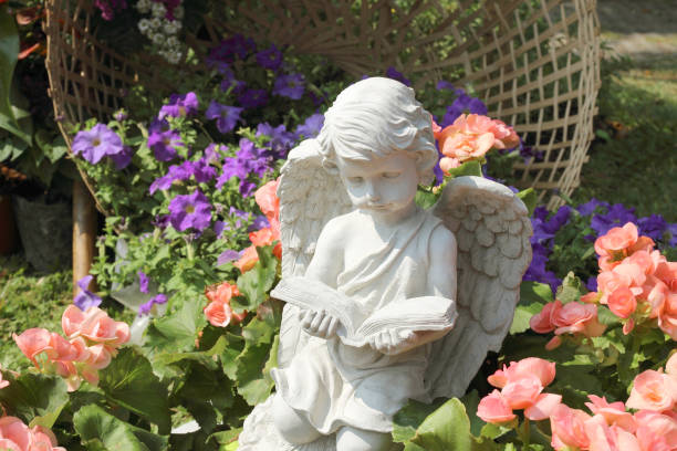 istock stone angel doll in garden 912345462