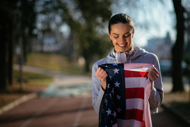 istock Female athlete in nature with American flag 912345586