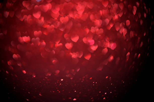 istock Red Blur heart shape of ligth bokeh on a black background 912348948