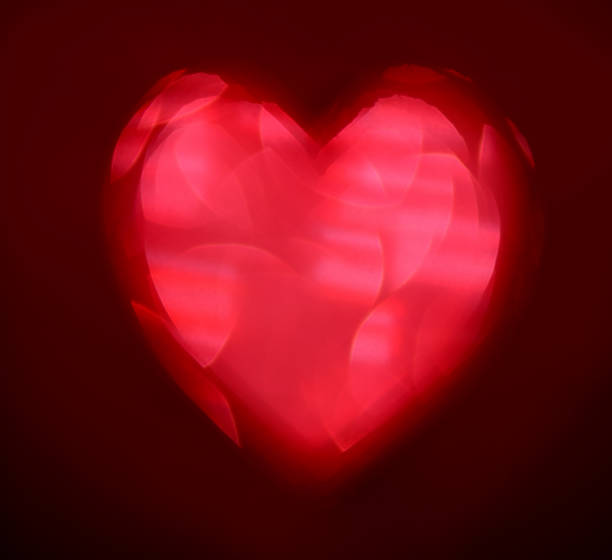 istock Red Blur heart shape of ligth bokeh on a black background 912349066