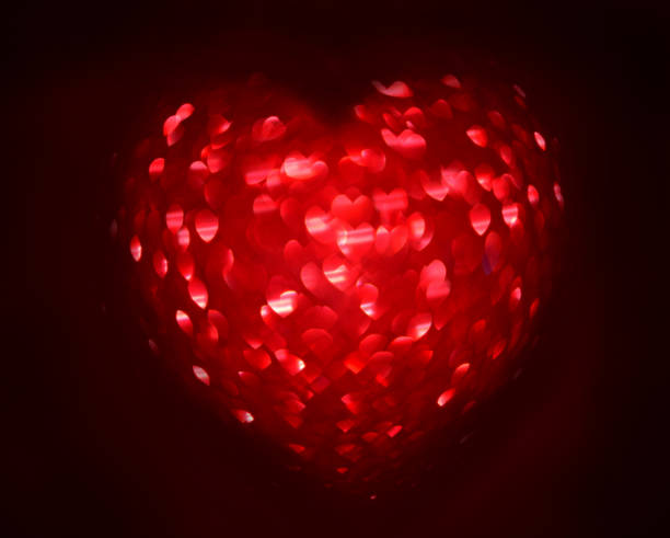 istock Red Blur heart shape of ligth bokeh on a black background 912349432
