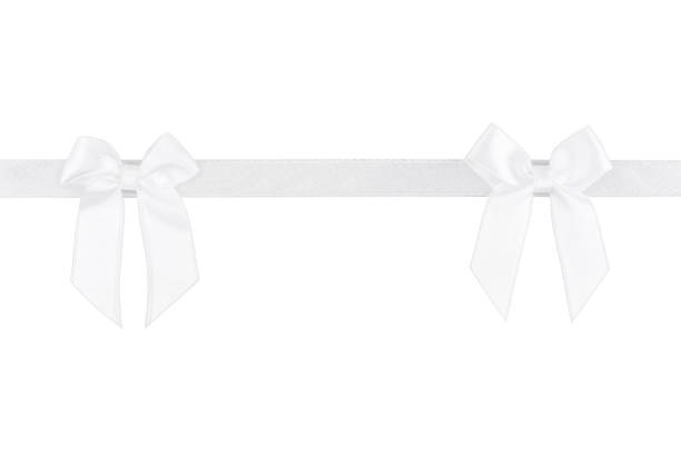 istock White silk ribbon with bows isolated on white background 912349630