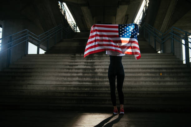 istock Young female athlete with American flag 912349702