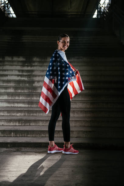 istock Young female runner with American flag 912352926