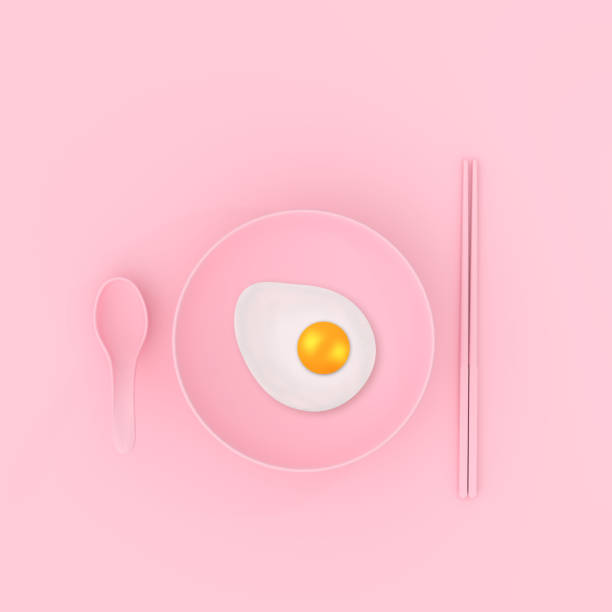 istock Fried egg on plate with spoon and chopsticks pink color. minimal concept 912353206