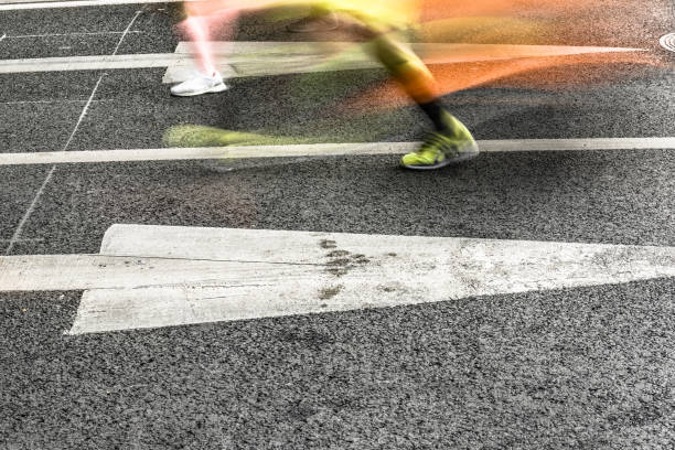 istock People running in marathon on city streets. Motion blur. 912353762