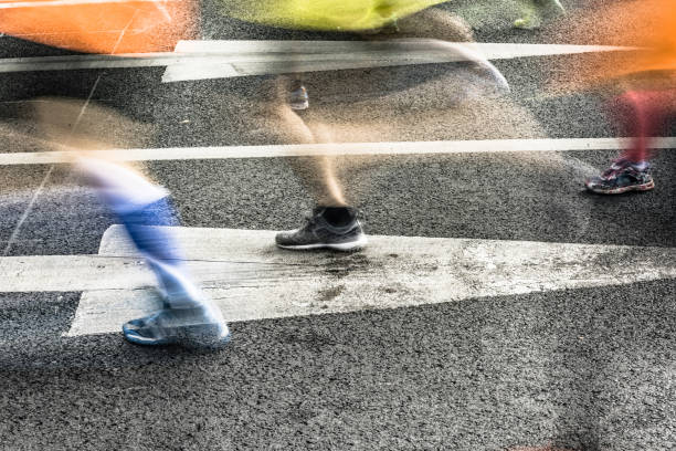 istock People running in marathon on city streets. Motion blur. 912353798