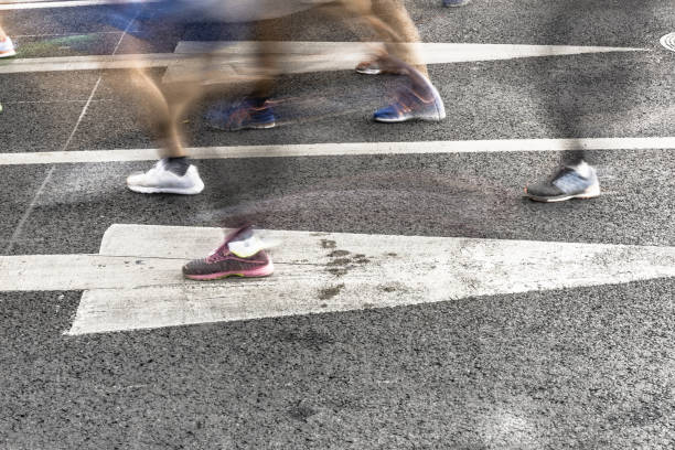 istock People running in marathon on city streets. Motion blur. 912353836
