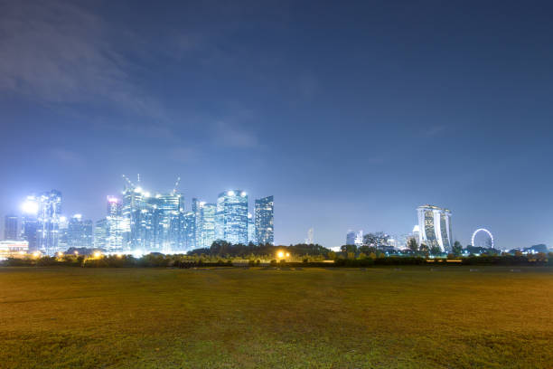 istock modern buildings near grass land at night 912356506