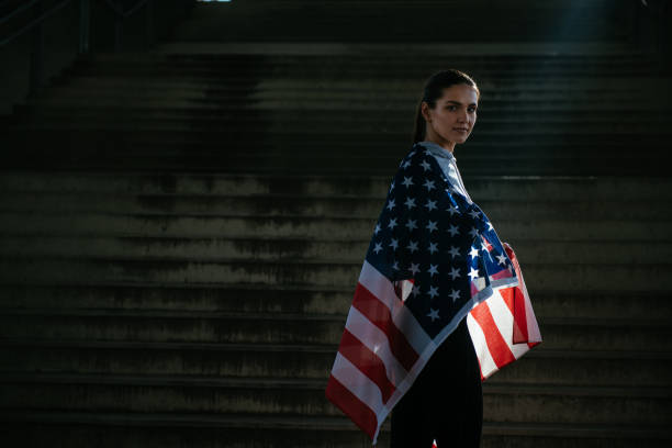 istock Young female athlete with American flag 912356536