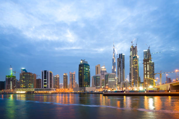 istock modern buildings near water at night 912356814