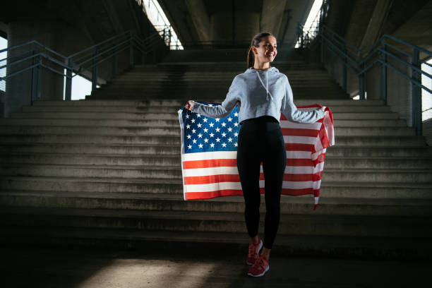 istock Young female runner with American flag 912359714