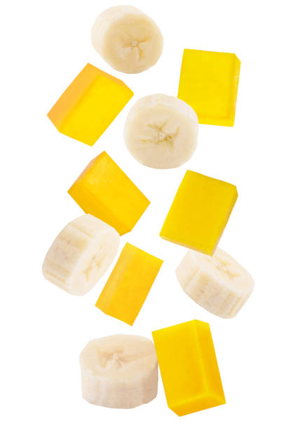 Falling sliced banana and mango isolated on white stock photo