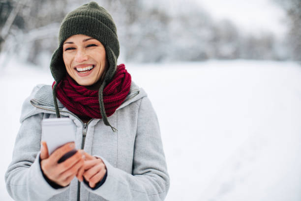 istock Woman using phone outdoors 912363794