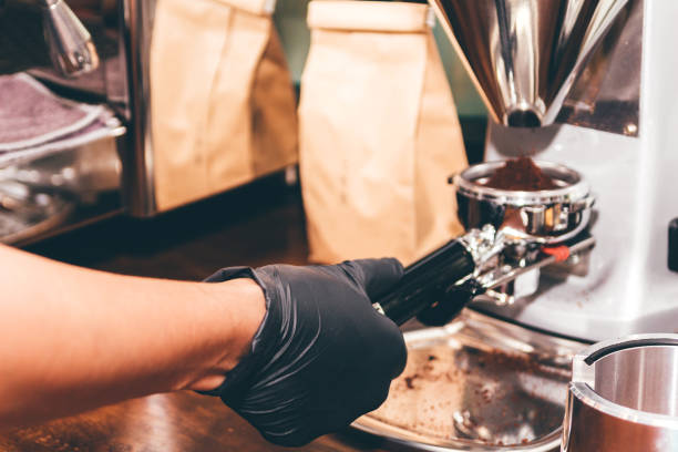 istock Women Barista using coffee machine for making coffee in the cafe 912364016